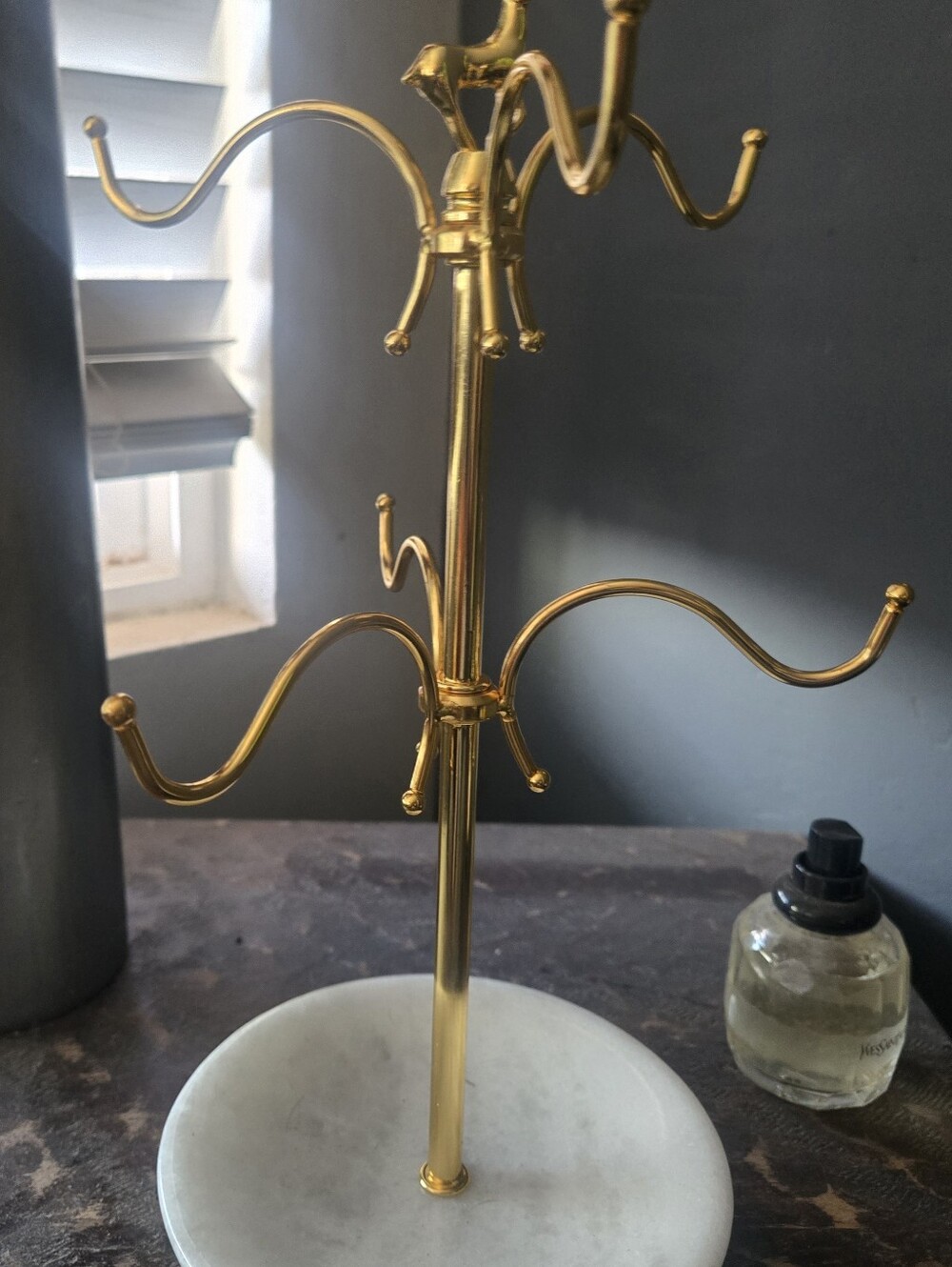 Gold Jewelry Stand on White Marble Base